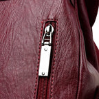 Leather knapsack with secure top flap