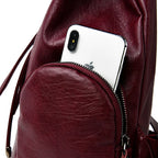 Leather knapsack with secure top flap