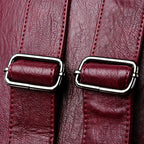 Leather knapsack with secure top flap