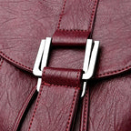 Leather knapsack with secure top flap