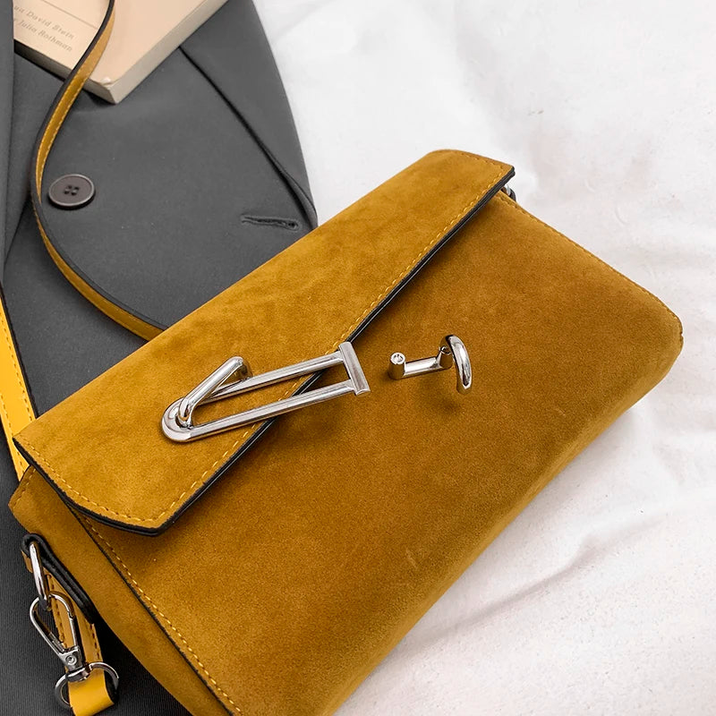 Structured suede handbag with minimalist shape