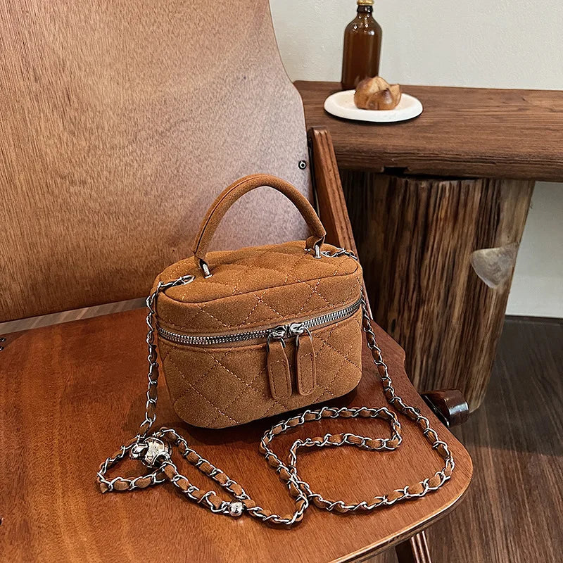 Classic suede handbag with structured handle