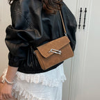 Structured suede handbag with minimalist shape