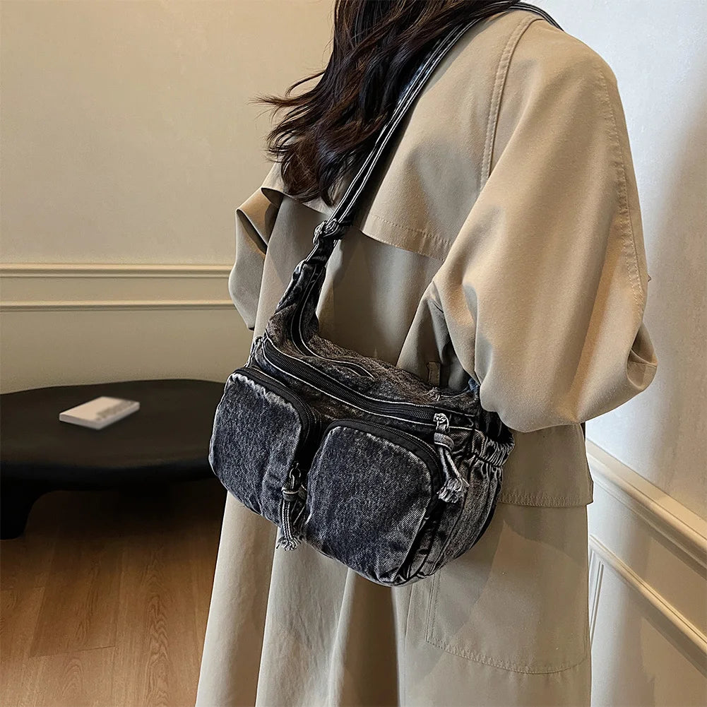 Denim shoulder bag with front pockets and buckle strap