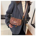 Sleek suede purse with wide shoulder strap