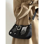 Edgy black denim handbag with buckle strap