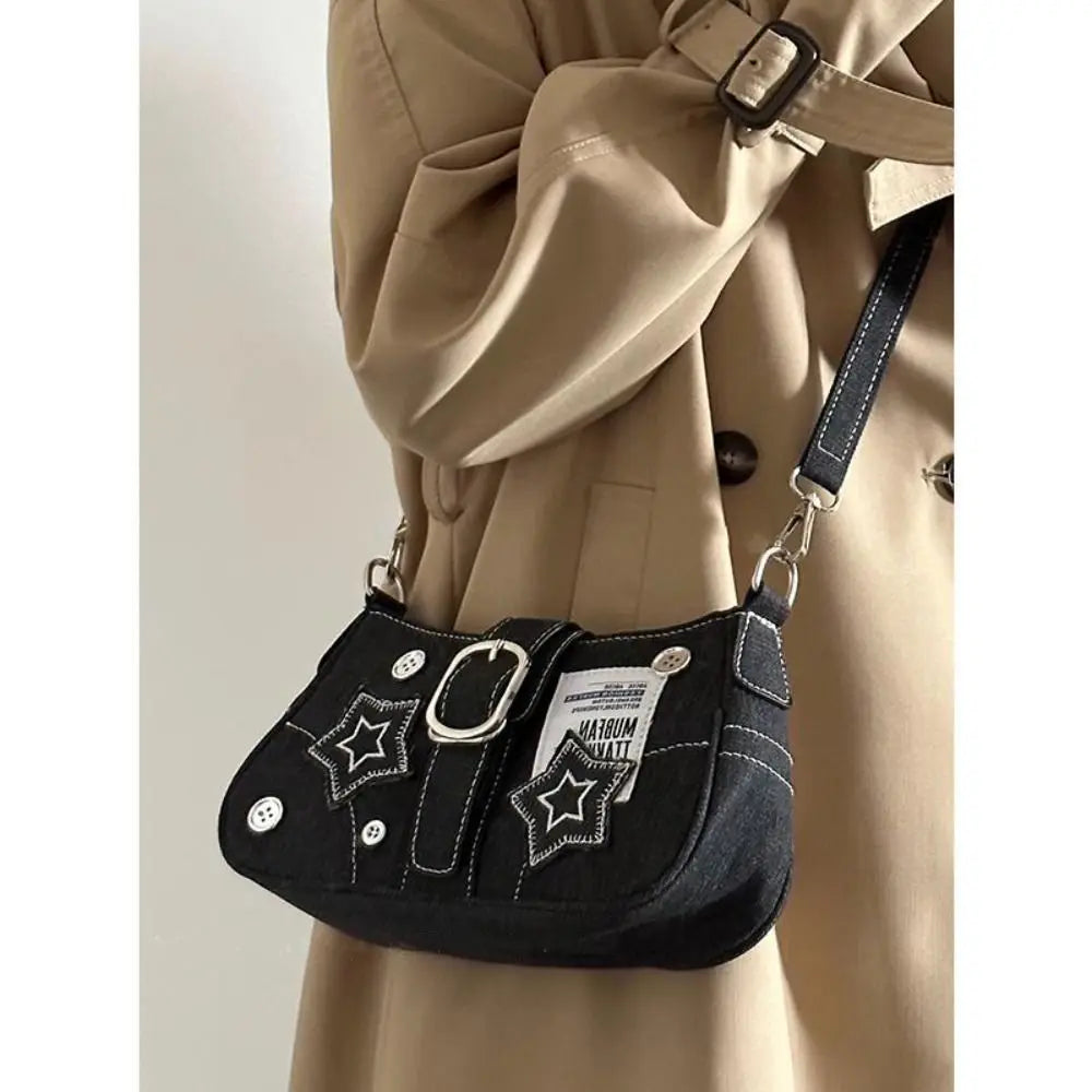Edgy black denim handbag with buckle strap