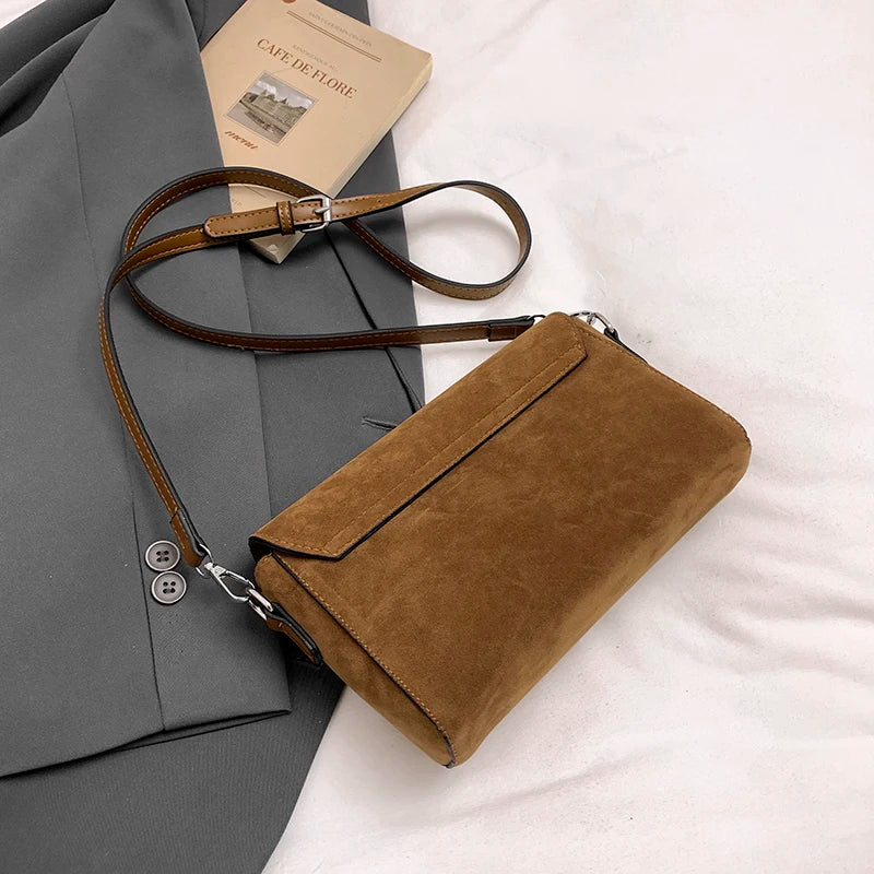 Structured suede handbag with minimalist shape