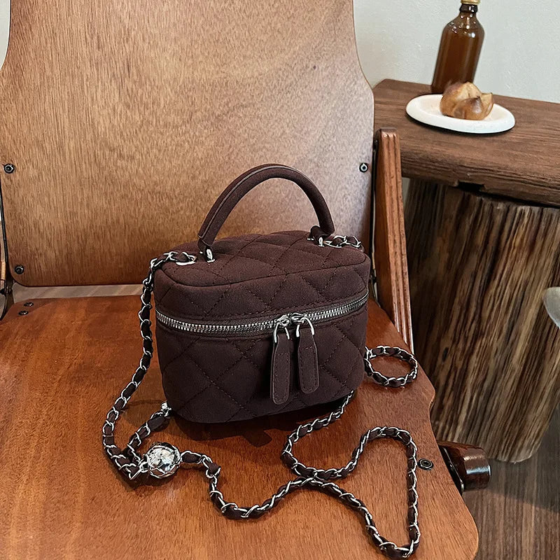 Classic suede handbag with structured handle