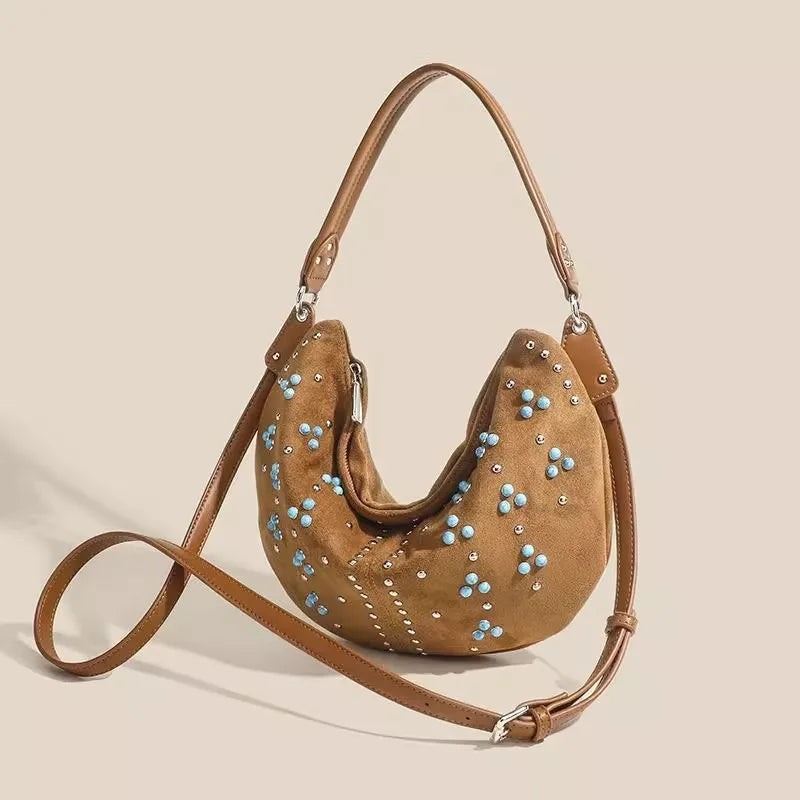 Soft suede handbag with elegant curved silhouette