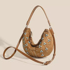 Soft suede handbag with elegant curved silhouette