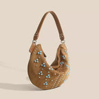 Soft suede handbag with elegant curved silhouette