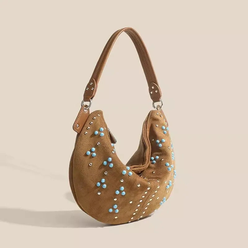 Soft suede handbag with elegant curved silhouette