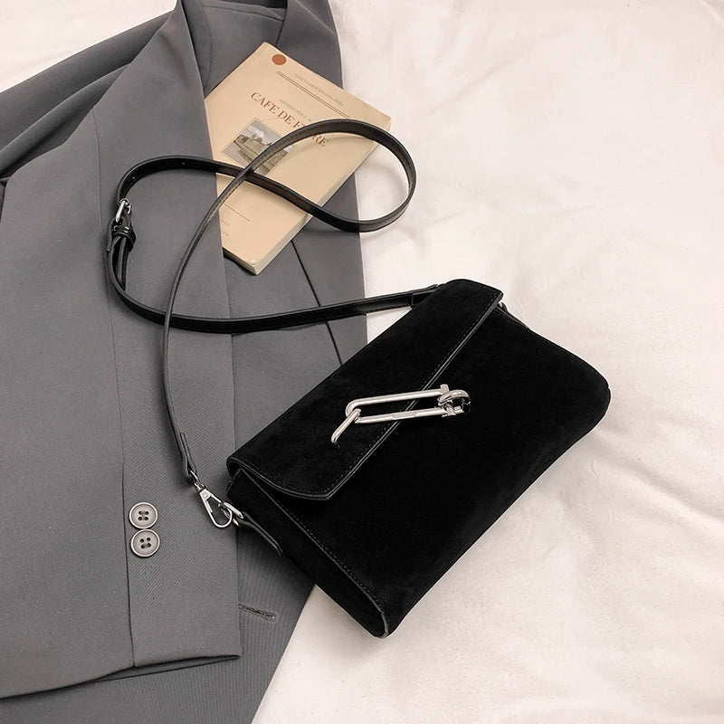 Structured suede handbag with minimalist shape