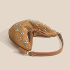 Soft suede handbag with elegant curved silhouette