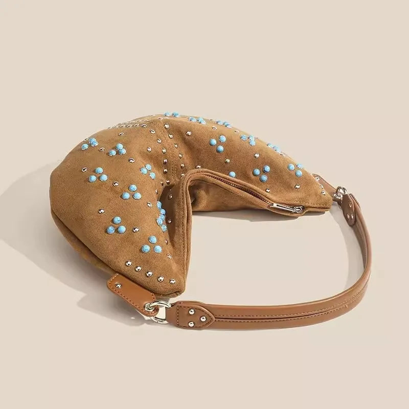 Soft suede handbag with elegant curved silhouette