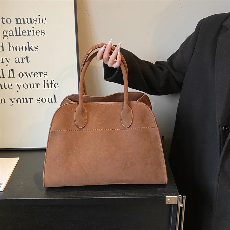 Suede handbag with shoulder strap