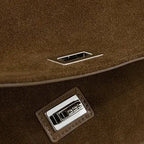 Textured suede handbag with flap closure