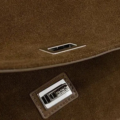Textured suede handbag with flap closure