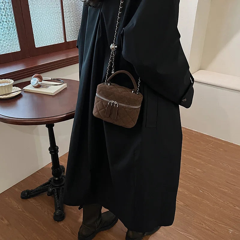 Classic suede handbag with structured handle