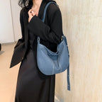Soft washed denim shoulder bag with casual fold design