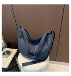 Soft washed denim shoulder bag with casual fold design