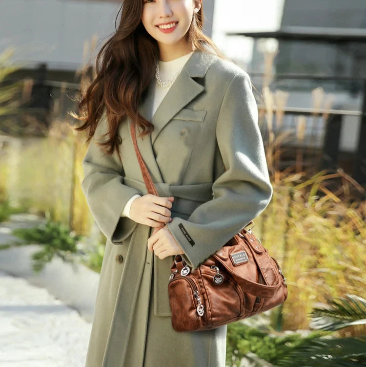 Leather shoulder bag with side pockets