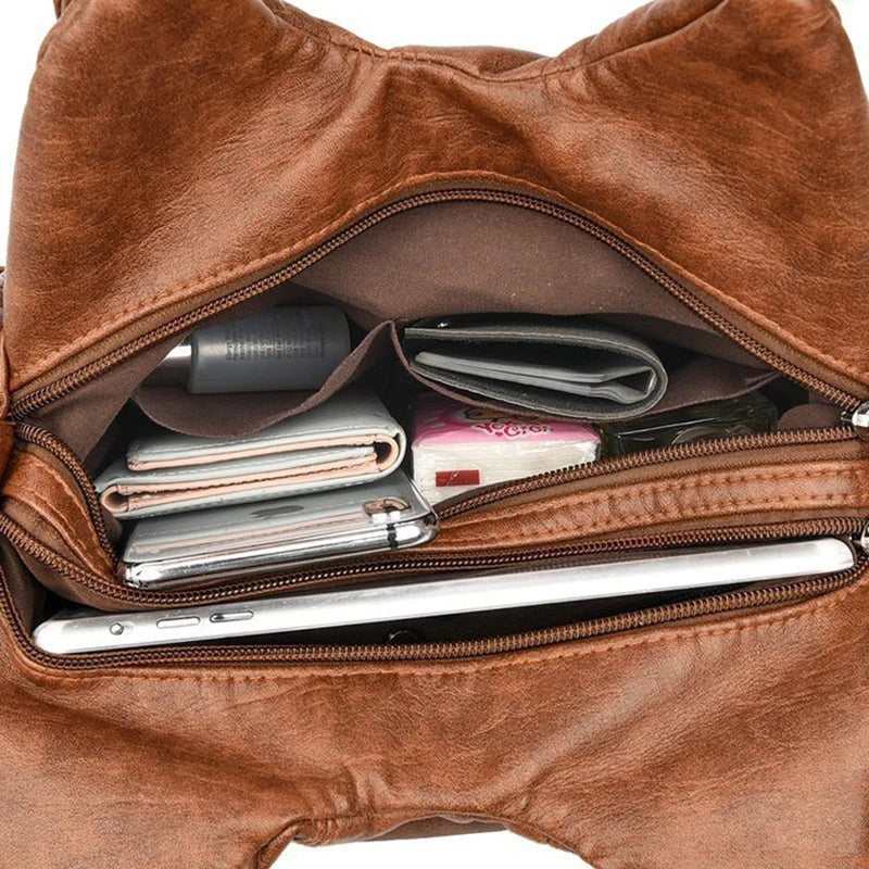 Leather shoulder bag with side pockets