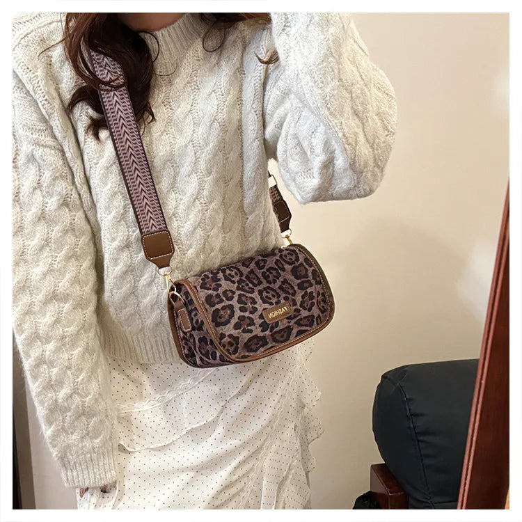Sleek suede purse with wide shoulder strap