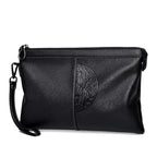 Minimalist leather clutch with detachable strap
