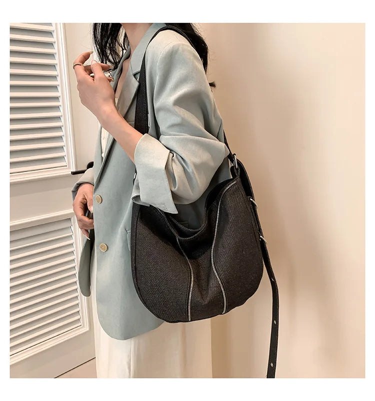 Soft washed denim shoulder bag with casual fold design