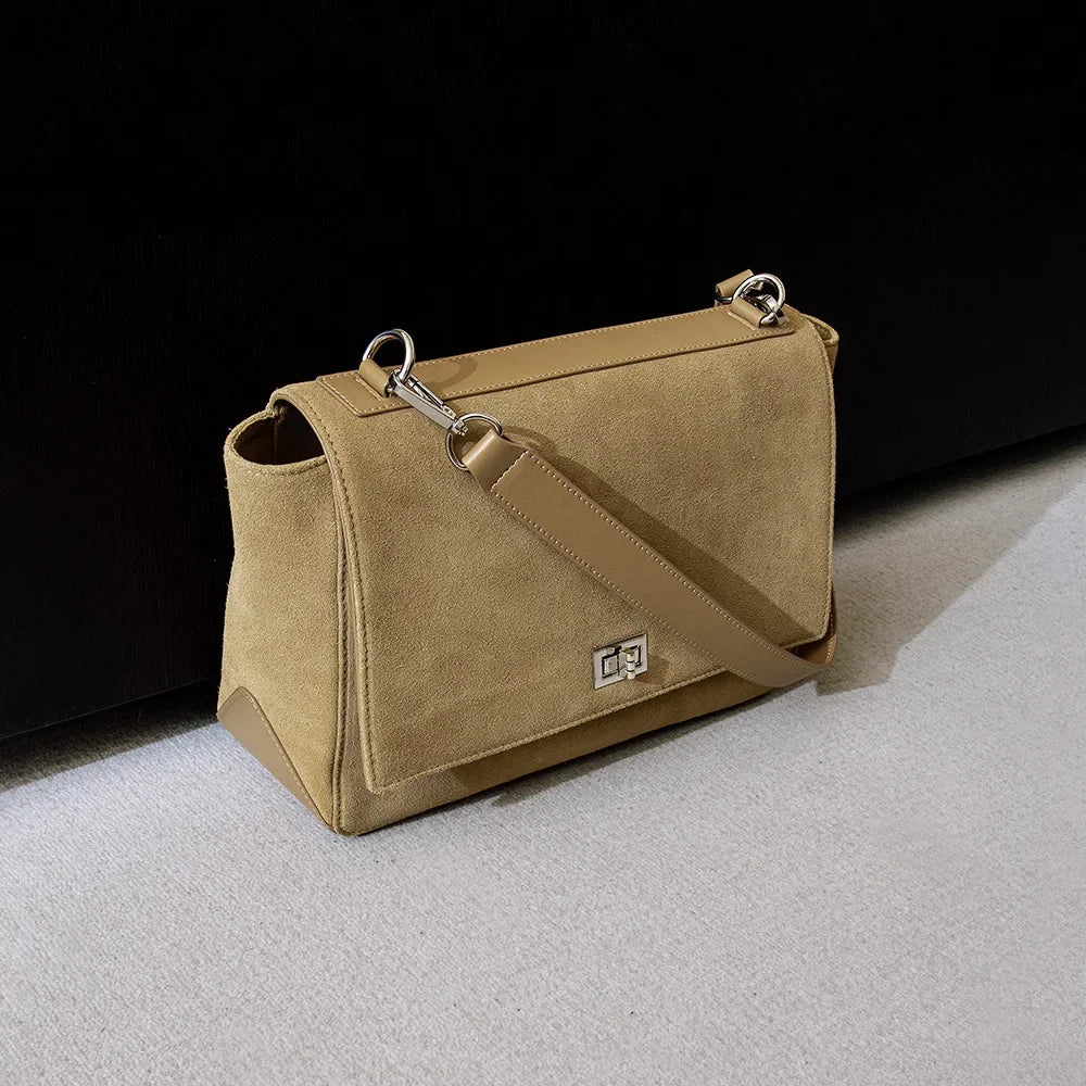 Textured suede handbag with flap closure