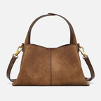 Suede handbag with rounded handles and zip closure