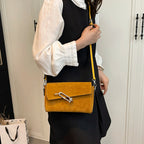 Structured suede handbag with minimalist shape