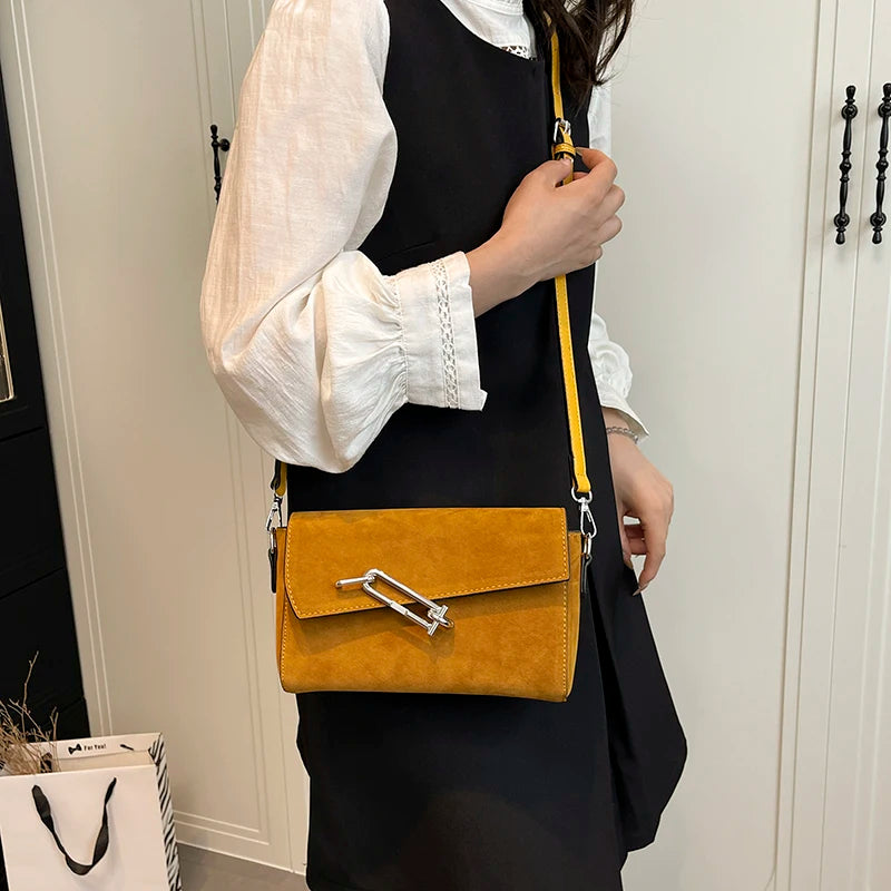 Structured suede handbag with minimalist shape