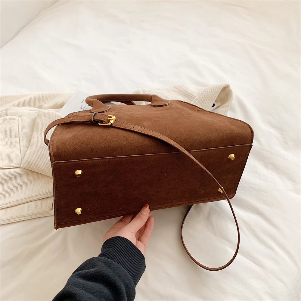 Suede handbag with shoulder strap