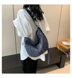 Soft washed denim shoulder bag with casual fold design