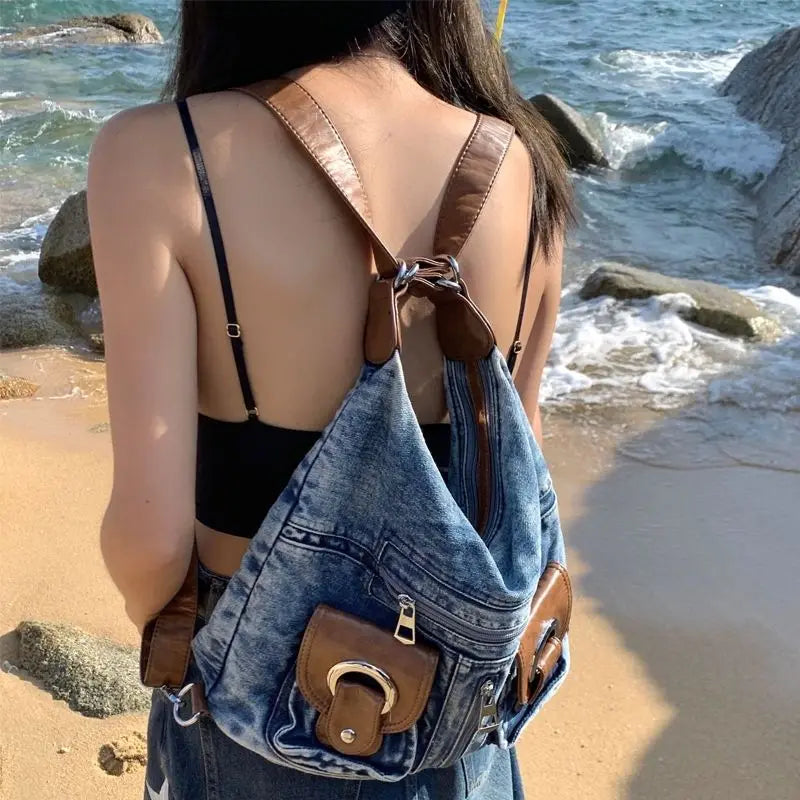 Trendy denim backpack with leather strap detail