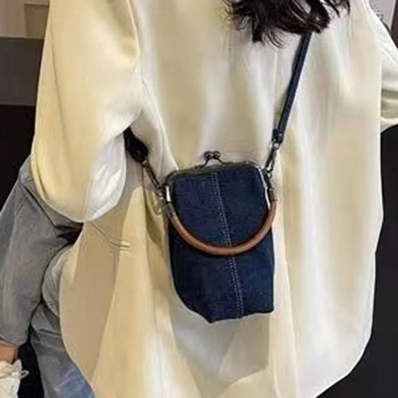 Distressed denim clutch bag with vintage vibes