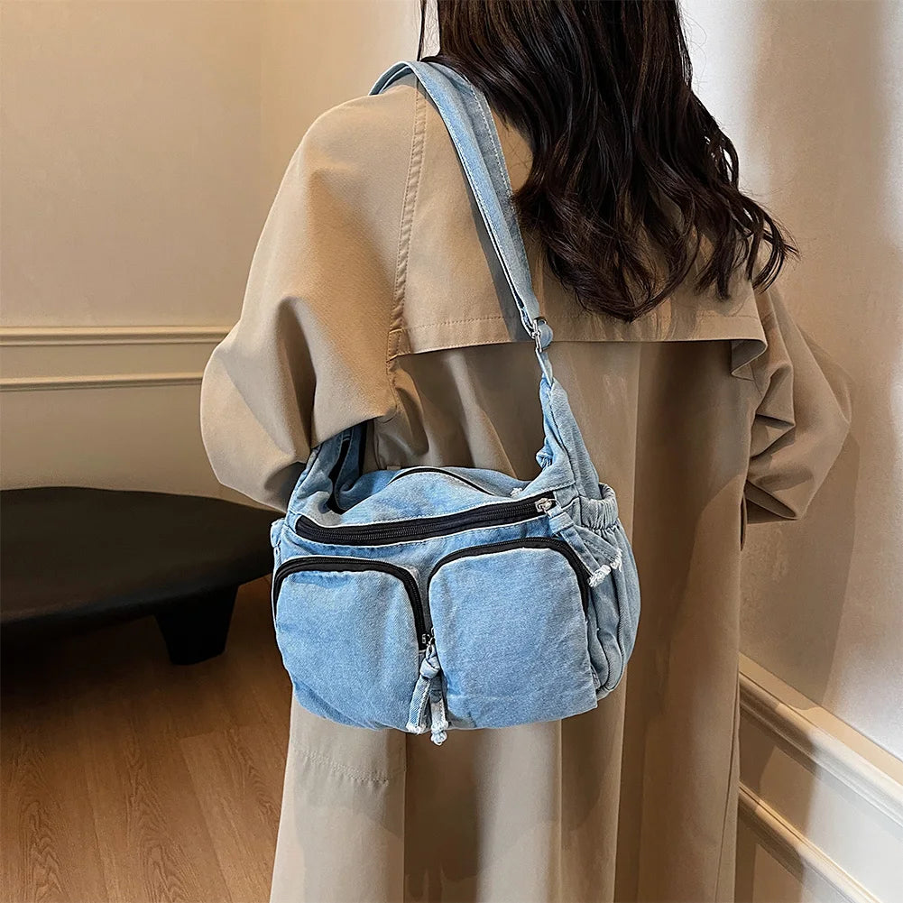 Denim shoulder bag with front pockets and buckle strap
