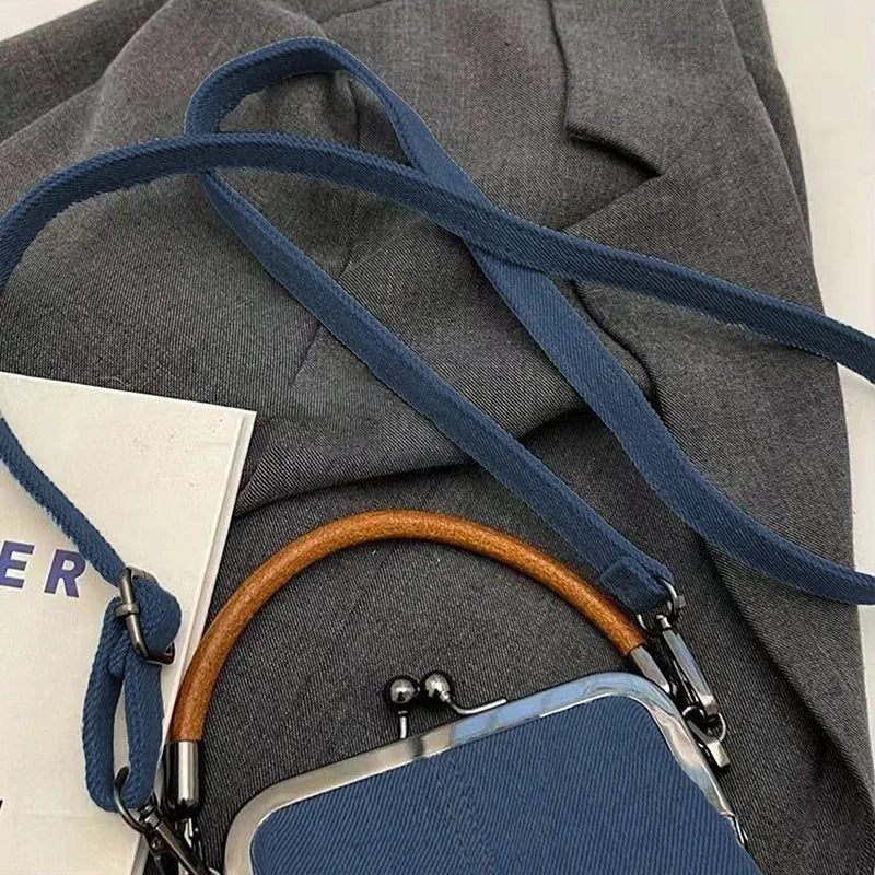 Distressed denim clutch bag with vintage vibes