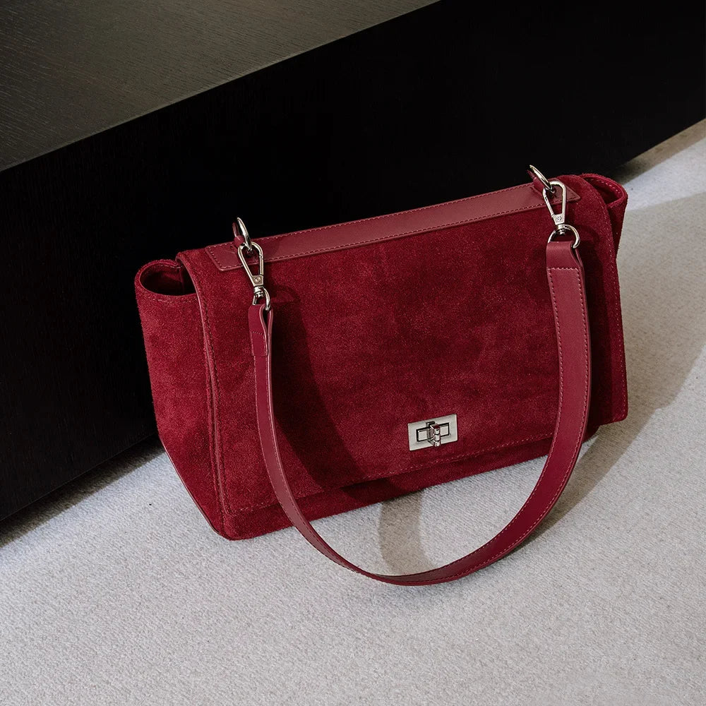 Textured suede handbag with flap closure