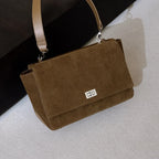 Textured suede handbag with flap closure