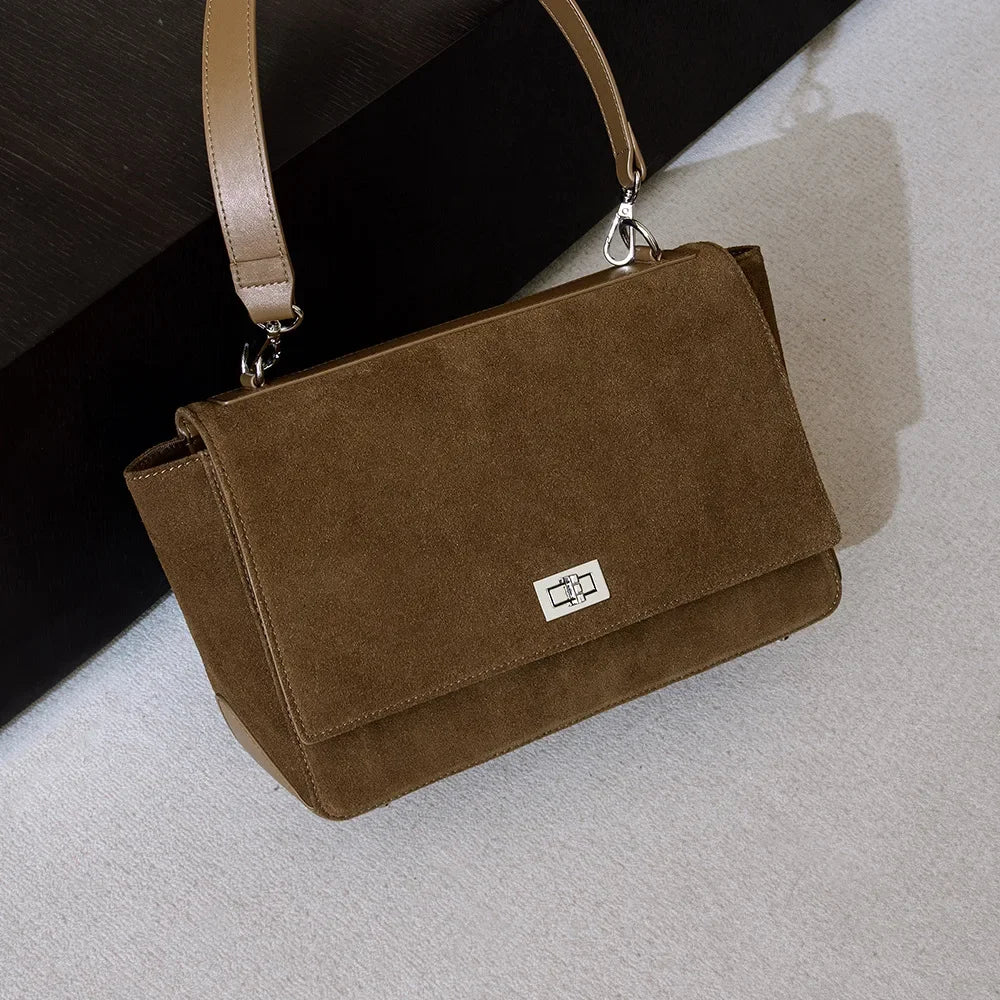 Textured suede handbag with flap closure
