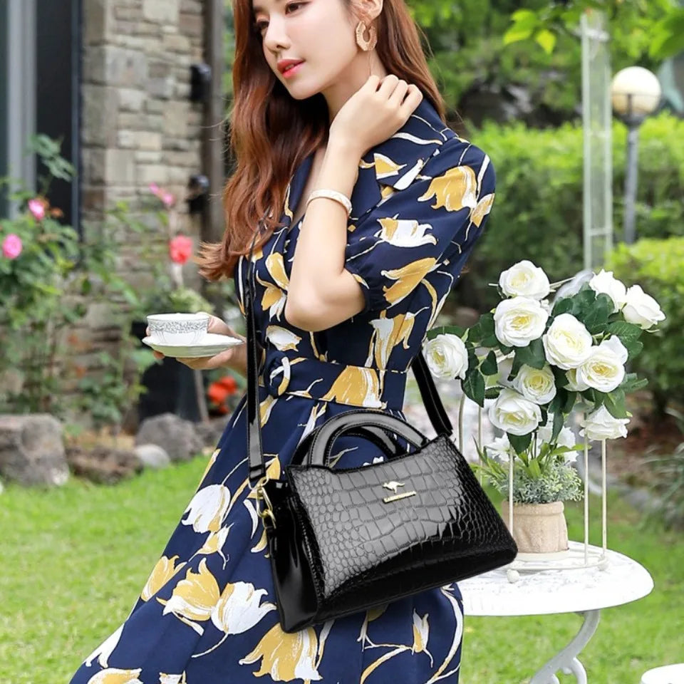 Soft leather handbag with curved top edge