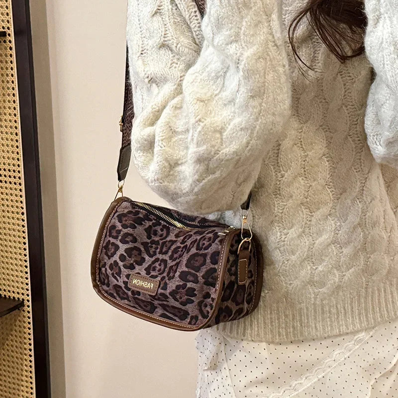 Sleek suede purse with wide shoulder strap