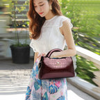 Soft leather handbag with curved top edge