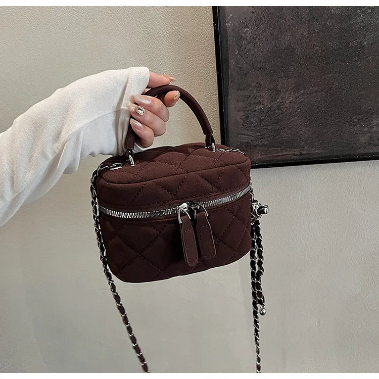 Classic suede handbag with structured handle