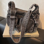 Denim shoulder bag with front pockets and buckle strap