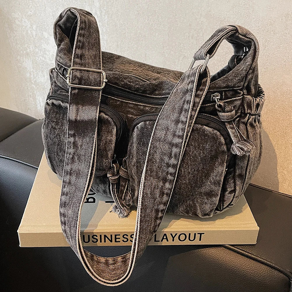 Denim shoulder bag with front pockets and buckle strap